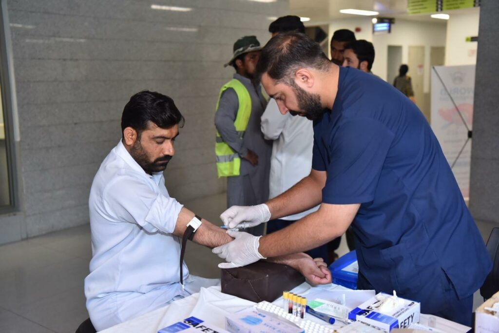 Doctor checking patient and taking blood sample